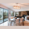 Wide-angle lifestyle shot of the table placed in a bright open-concept living area with large windows