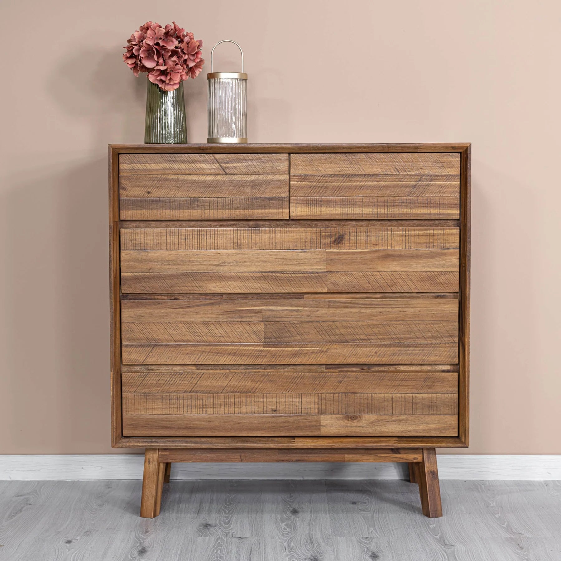 Studio lifestyle shot featuring the warm pecan chest styled with a simple floral arrangement in a bright contemporary room