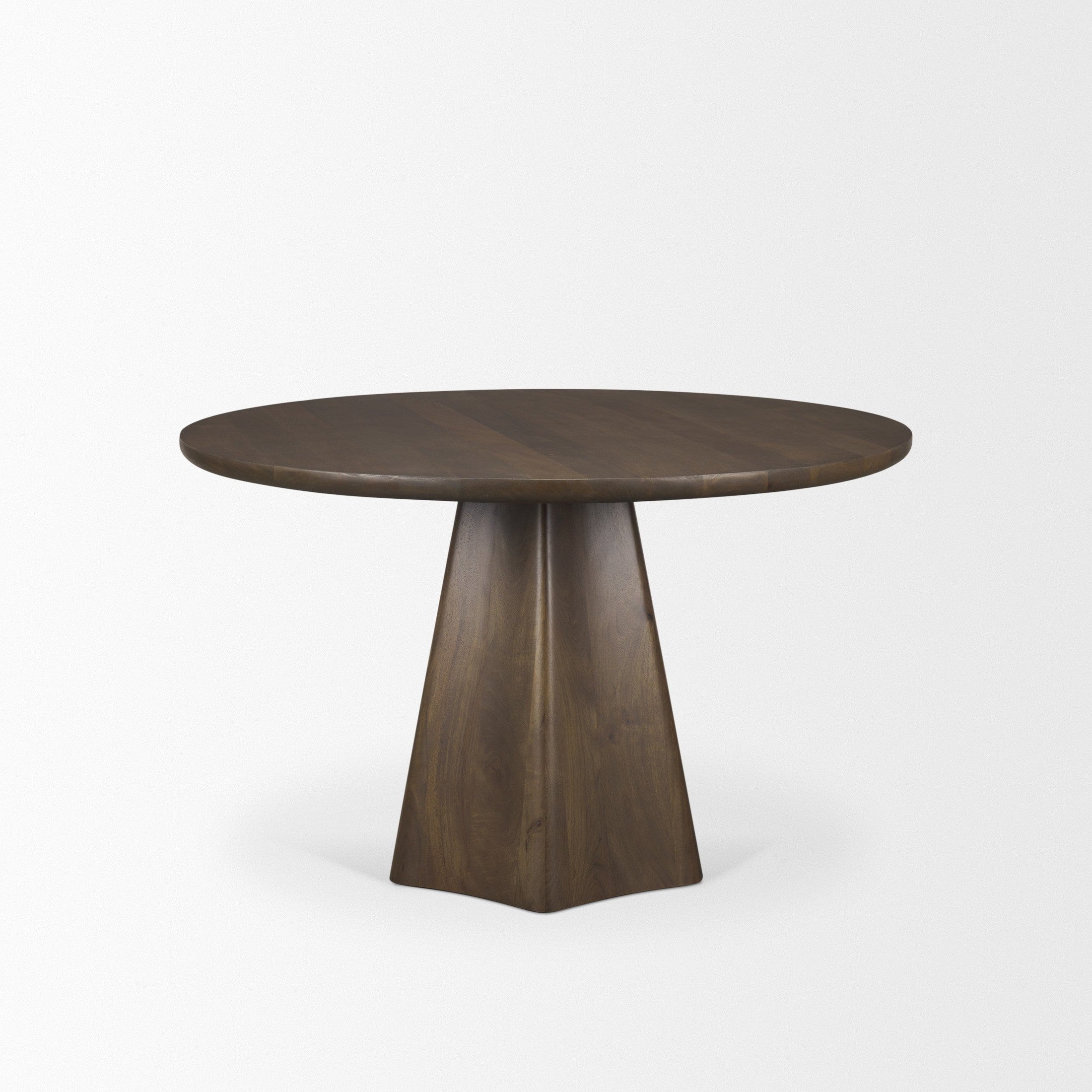 Front view of the Jovani round dining table in a dark mango wood finish featuring a sculptural faceted pedestal base