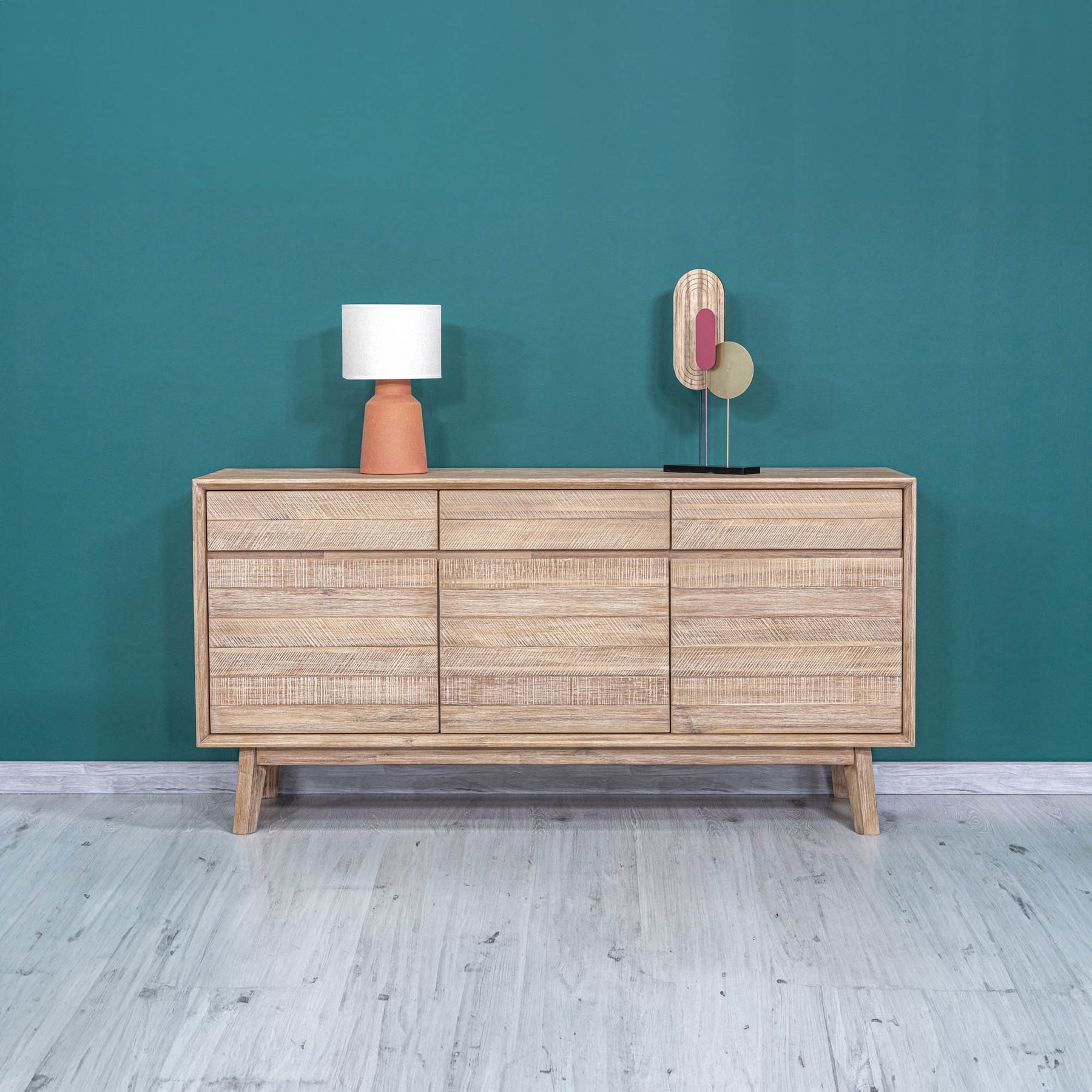 Front perspective view of the Gia sideboard featuring natural wood construction with horizontal textured paneling and three top drawers