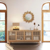 Lifestyle shot of the oak sideboard styled with a sunburst mirror and neutral decor in a bright contemporary room