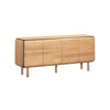 Front perspective view of the Distillery sideboard showcasing the seamless wood grain across four doors and the contrasting black decorative trim