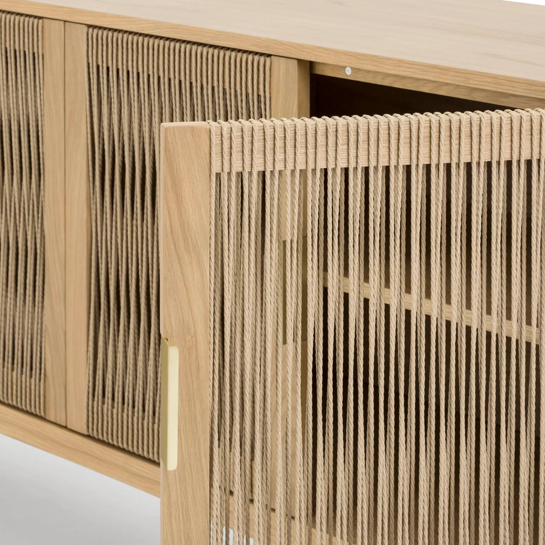 Front perspective view of the Lumina 4-door sideboard featuring a light oak wood frame, fluted glass door panels, and elegant vertical gold metal handles