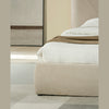 Perspective shot of the side rail focusing on the plush cushioning and the neutral cream upholstery finish