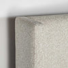 Perspective detail shot focusing on the rounded corner of the platform base and the rich tactile dune fabric