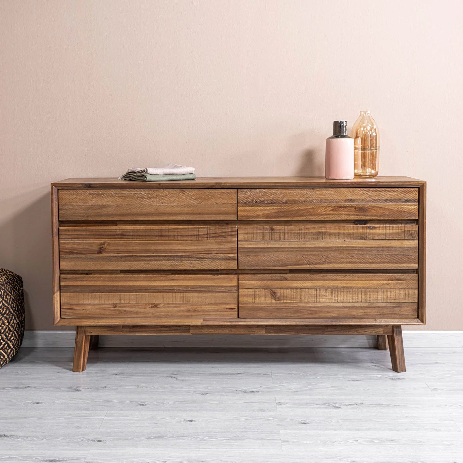 Lifestyle perspective featuring the Gia 6-drawer dresser in warm pecan styled in a bright bedroom setting with contemporary decor accents
