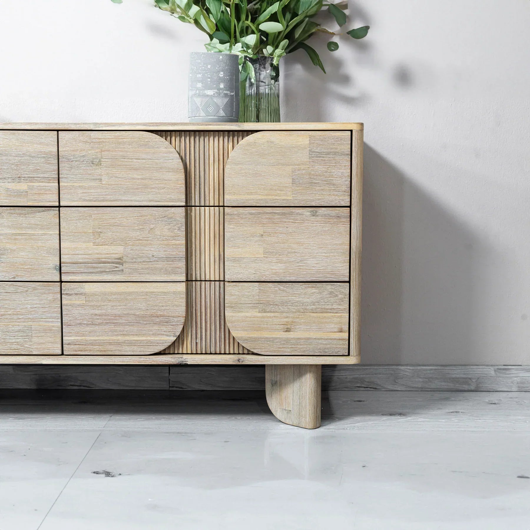 Front view of the Haru double dresser featuring a light white oak finish and a unique fluted facade with soft rounded paneling