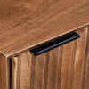 Macro detail shot focusing on the tactile wood grain and the precision of the diagonal hand-carved geometric grooves