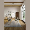 Close-up shot emphasizing the architectural rounded tapered leg design and smooth wood joinery