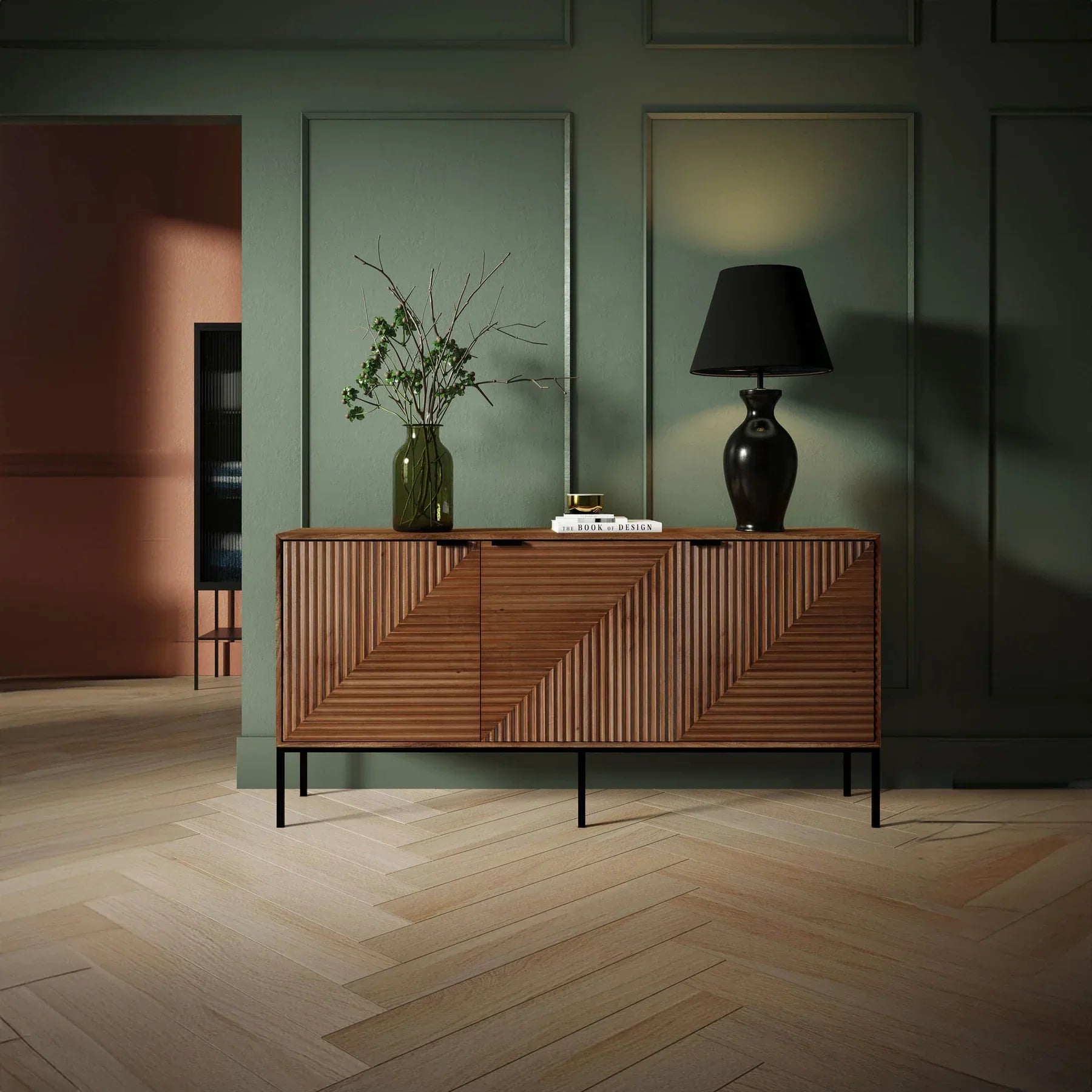 Front view of the Nikita sideboard featuring a warm wood finish with intricate chevron-patterned ribbed door panels and slim black metal legs