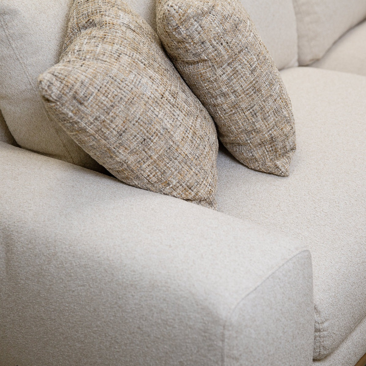 Front view of Mylo 3-seater cream sofa with wood base