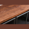 Macro shot focusing on the warm natural wood grain and high-quality finish of the sideboard's top surface