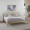 Close-up shot focusing on the tactile natural linen fabric and the high-quality wood grain joinery of the ginger ash frame