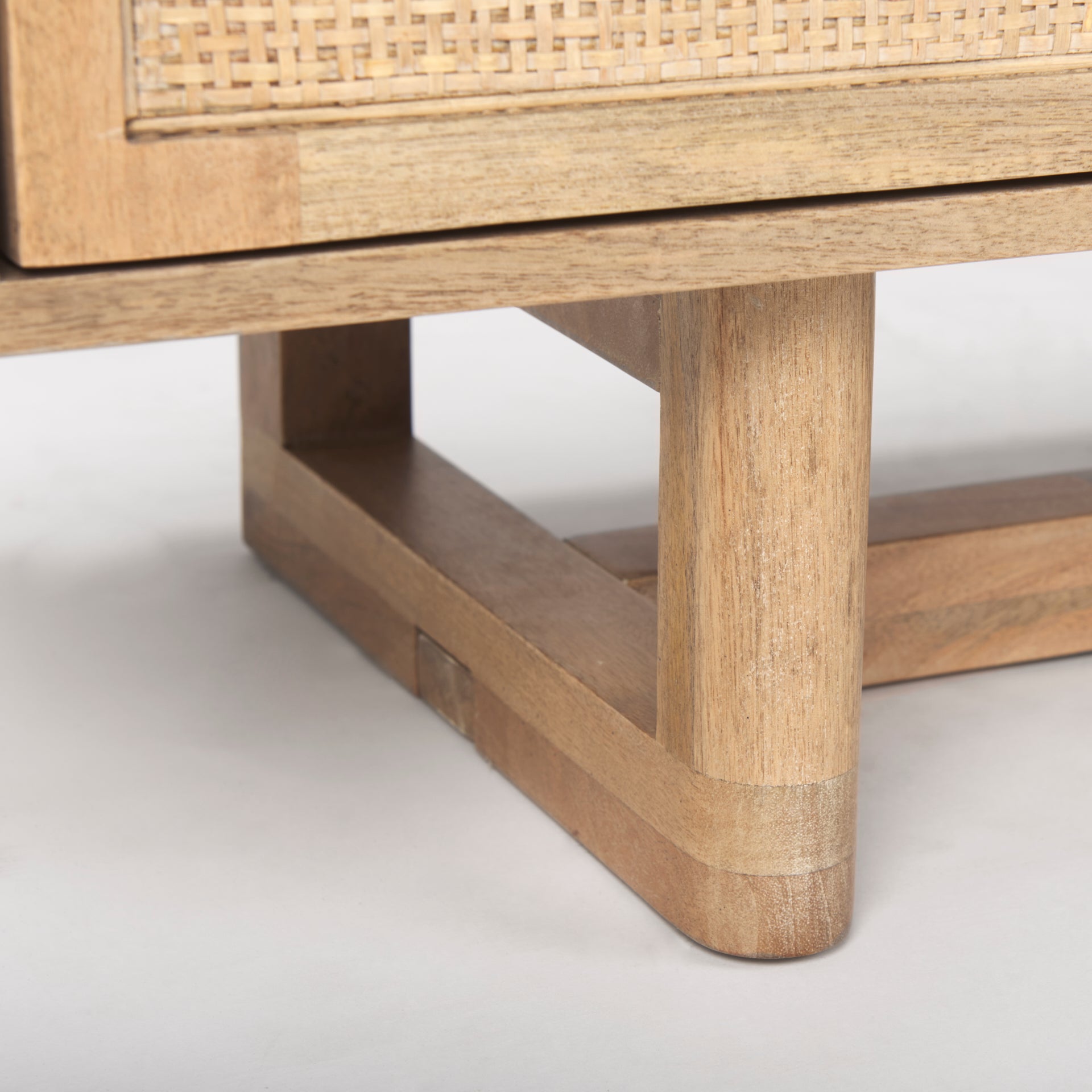 Close-up shot of the solid wood T-base leg construction providing structural stability and a modern silhouette