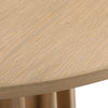Close-up high-angle view highlighting the authentic wood grain and smooth polished surface of the circular oak tabletop