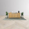 Perspective studio shot of the Arizona sideboard positioned between two floor plants in a bright minimalist room