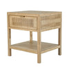 Three-quarter view of a light oak side table featuring natural rattan caning on the drawer front and side panels