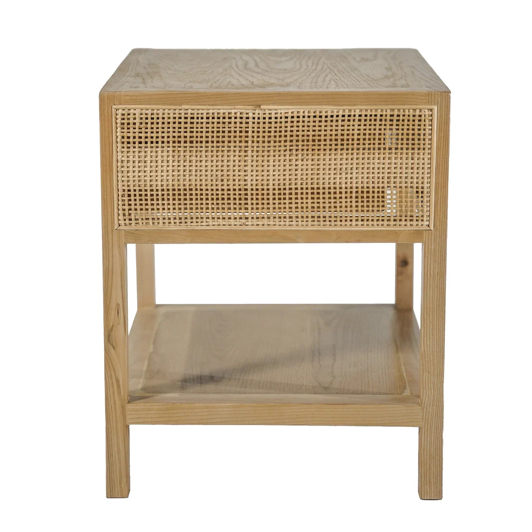 Straight-on front view showcasing the woven rattan drawer front and minimalist brass hardware on a light wood frame