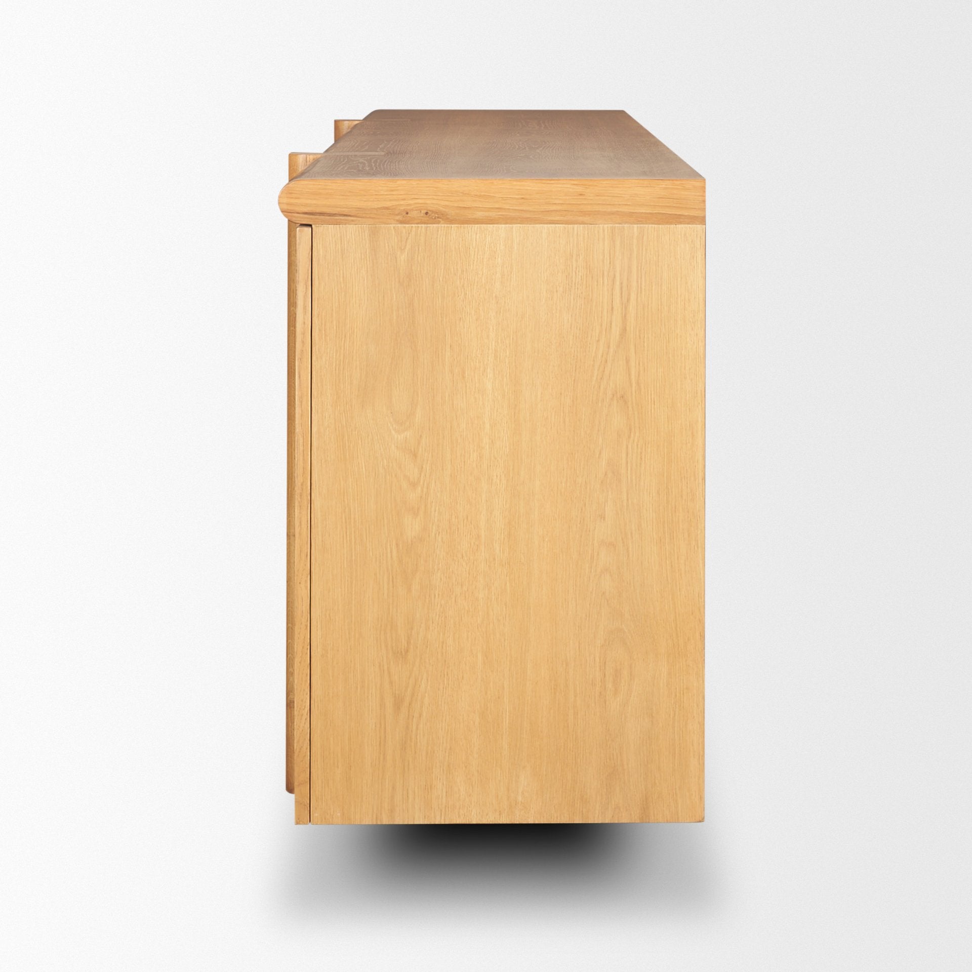 Side profile view of the natural oak sideboard showcasing the clean vertical lines and the wrap-around leg detail