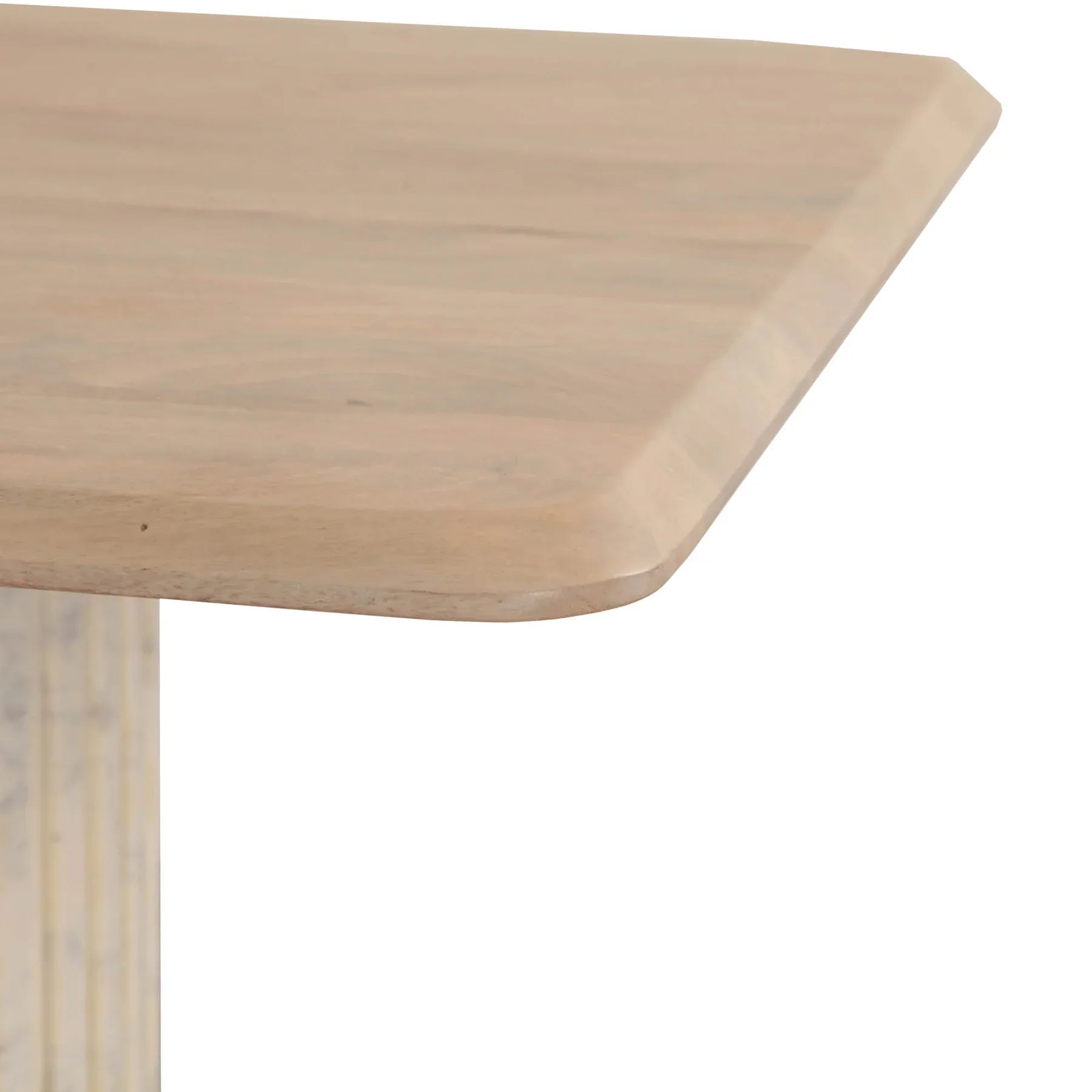 Front view of the Hedron dining table in a natural oak finish featuring rounded corners and two thick ribbed pedestal legs