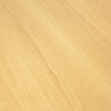 Macro bird's-eye view detail highlighting the seamless natural wood grain patterns of the circular oak tabletop