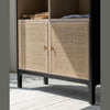 Close-up shot focusing on the high-quality woven rattan door panels and small circular gold metal pulls
