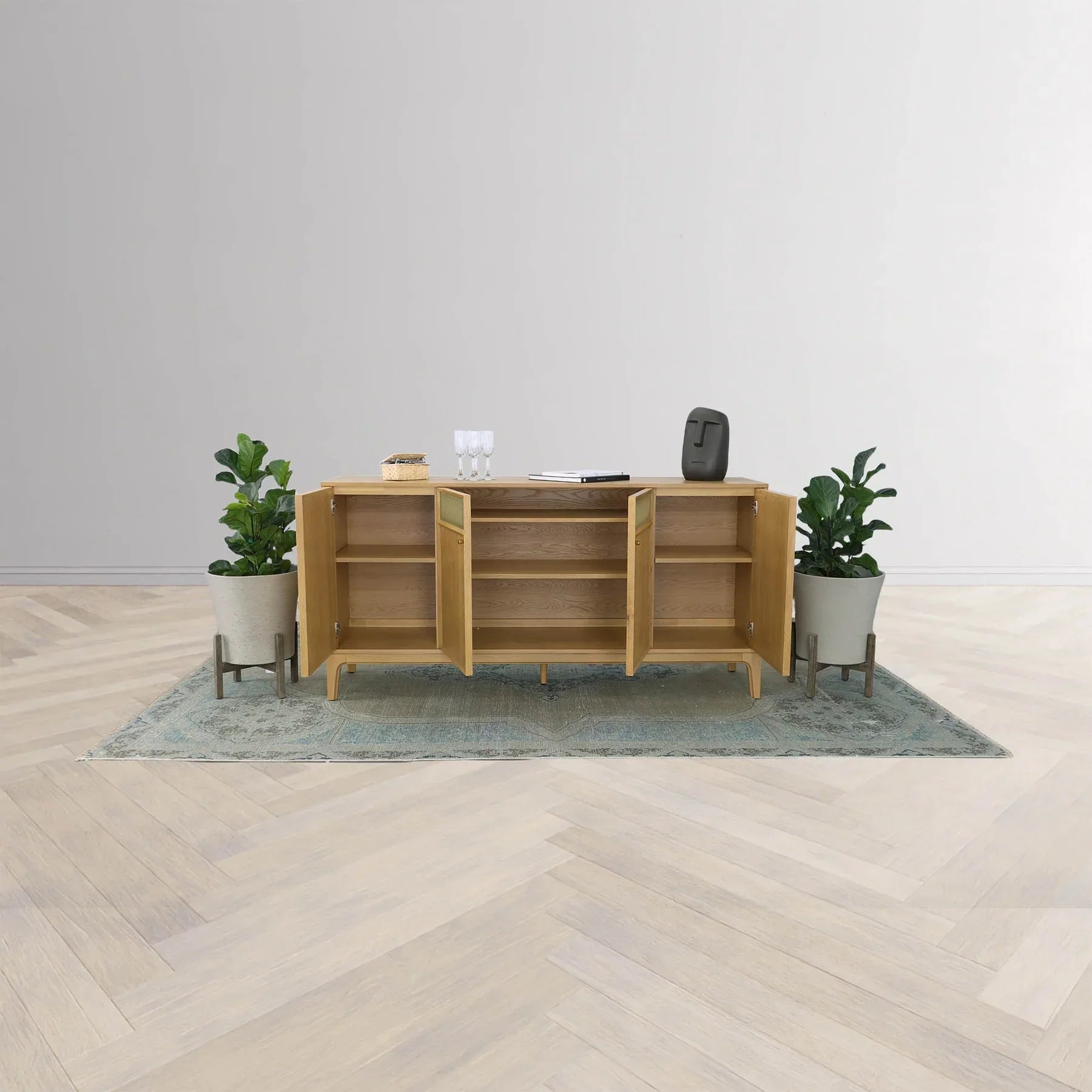 Three-quarter perspective view of the Arizona 4-door sideboard in a natural oak finish featuring two central metal mesh door inlays and tapered wood legs