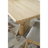 Macro detail shot focusing on the high-quality joinery and the rich texture of the Lioness finish on the table corner
