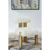 Lifestyle shot of the Nelly chair styled in a bright minimalist room with contemporary wall art and light wood flooring