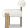 Side profile demonstrating the clean architectural lines of the wooden frame and the cushioned sheepskin backrest