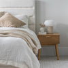 Lifestyle perspective highlighting the tonal harmony between the cream bed and light wood furniture