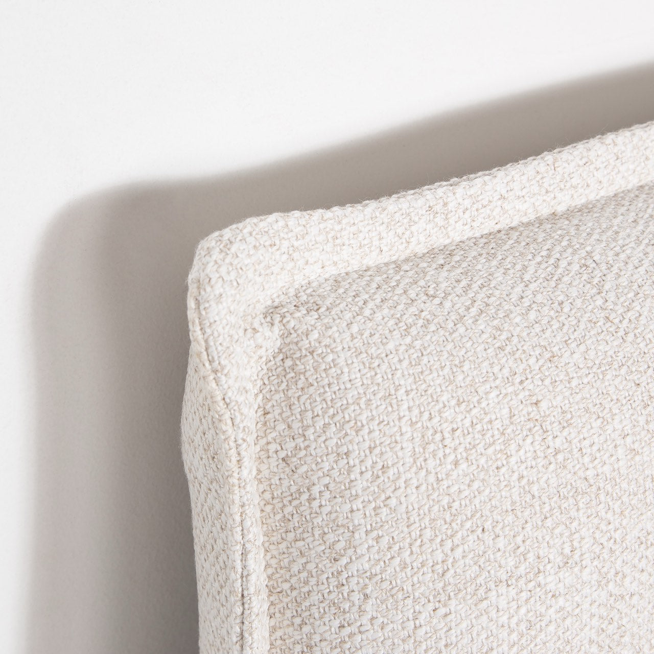 Front view highlighting the soft textured upholstery and the clean architectural lines of the bed frame