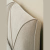 Lifestyle shot focusing on the tonal harmony between the cream bed and the surrounding soft neutral decor