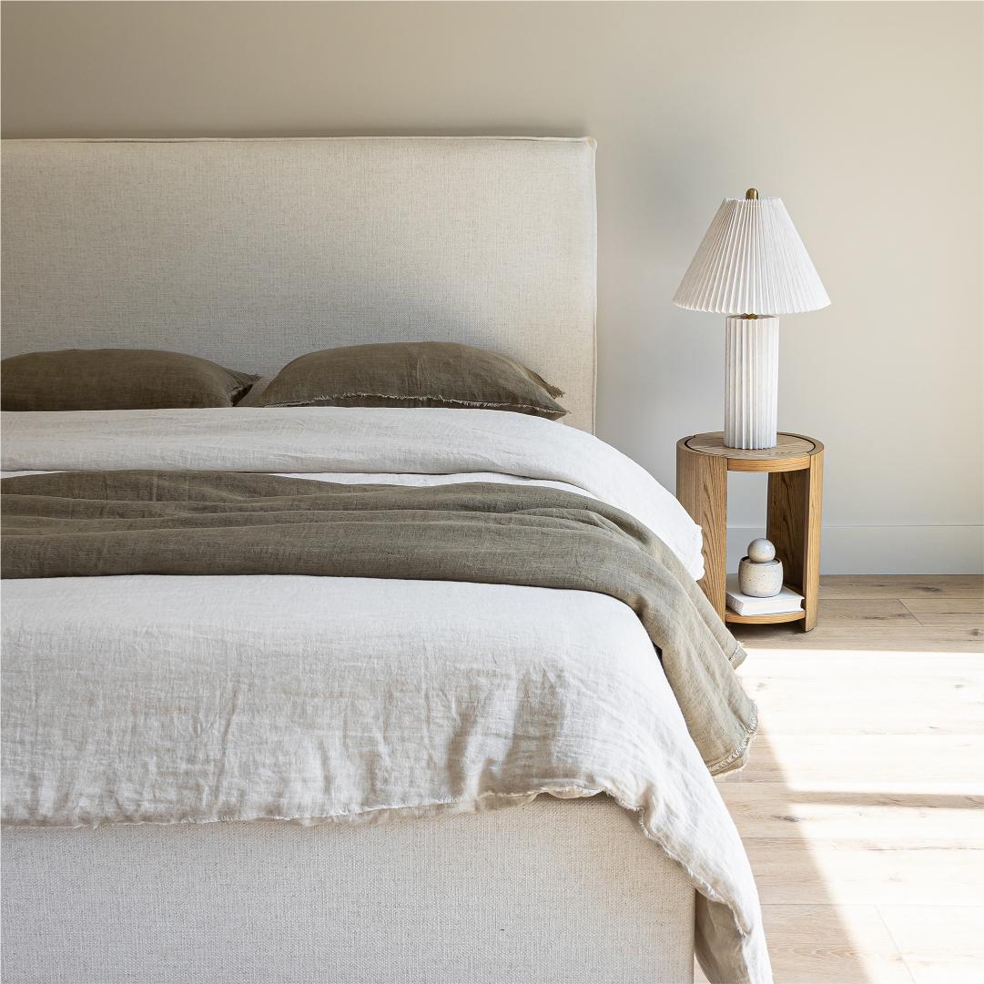 Front view highlighting the soft textured upholstery and the clean architectural lines of the bed frame
