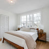 Alternate lifestyle perspective showing the nightstand in a bright, minimalist bedroom with light oak flooring and neutral bedding