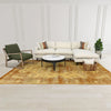 High-angle lifestyle shot of the marble coffee table styled with a green armchair and neutral interior accents