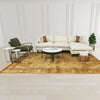 Wide lifestyle view showcasing the table in a complete furniture suite including a cream sofa and forest green chairs