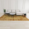 Lifestyle shot featuring the Nila marble table centered in a bright living room with a white sectional sofa and golden rug