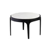 Front view of the Nila coffee table featuring a thick circular white marble top supported by a minimalist four-legged black metal base