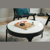 Close-up shot featuring a charcuterie board styled on the smooth white marble surface of the Nila table