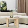 Close-up lifestyle shot of the Nils coffee table surface styled with a black decorative book and a geometric vase