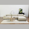 Lifestyle shot featuring the Nils coffee table styled with a white modular sectional sofa in a bright contemporary living room