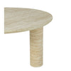 Close-up shot focusing on the smooth rounded edge of the circular travertine tabletop and the top of a pedestal leg