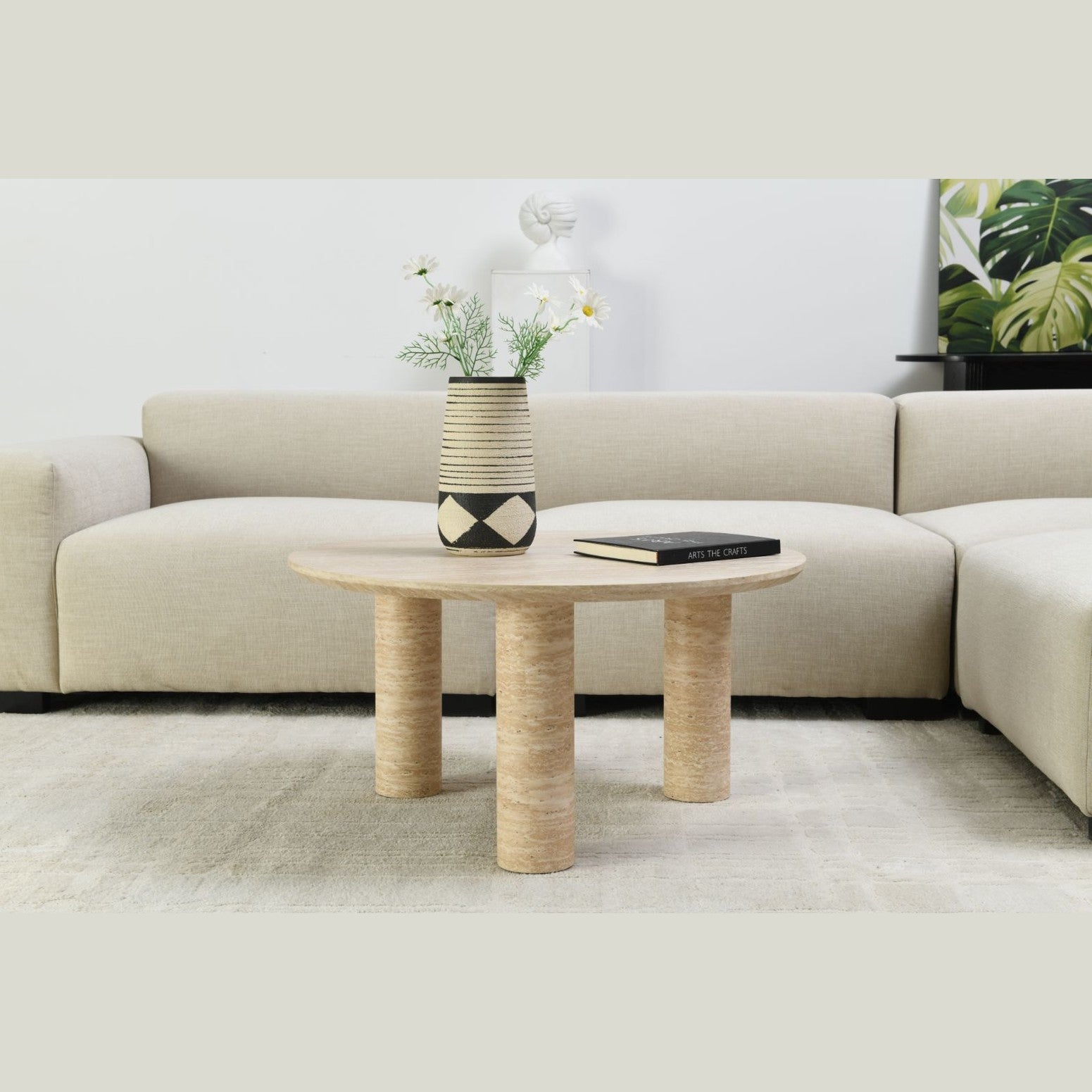 Interior shot of the Nils coffee table styled with a decorative vase and greenery in a modern living space
