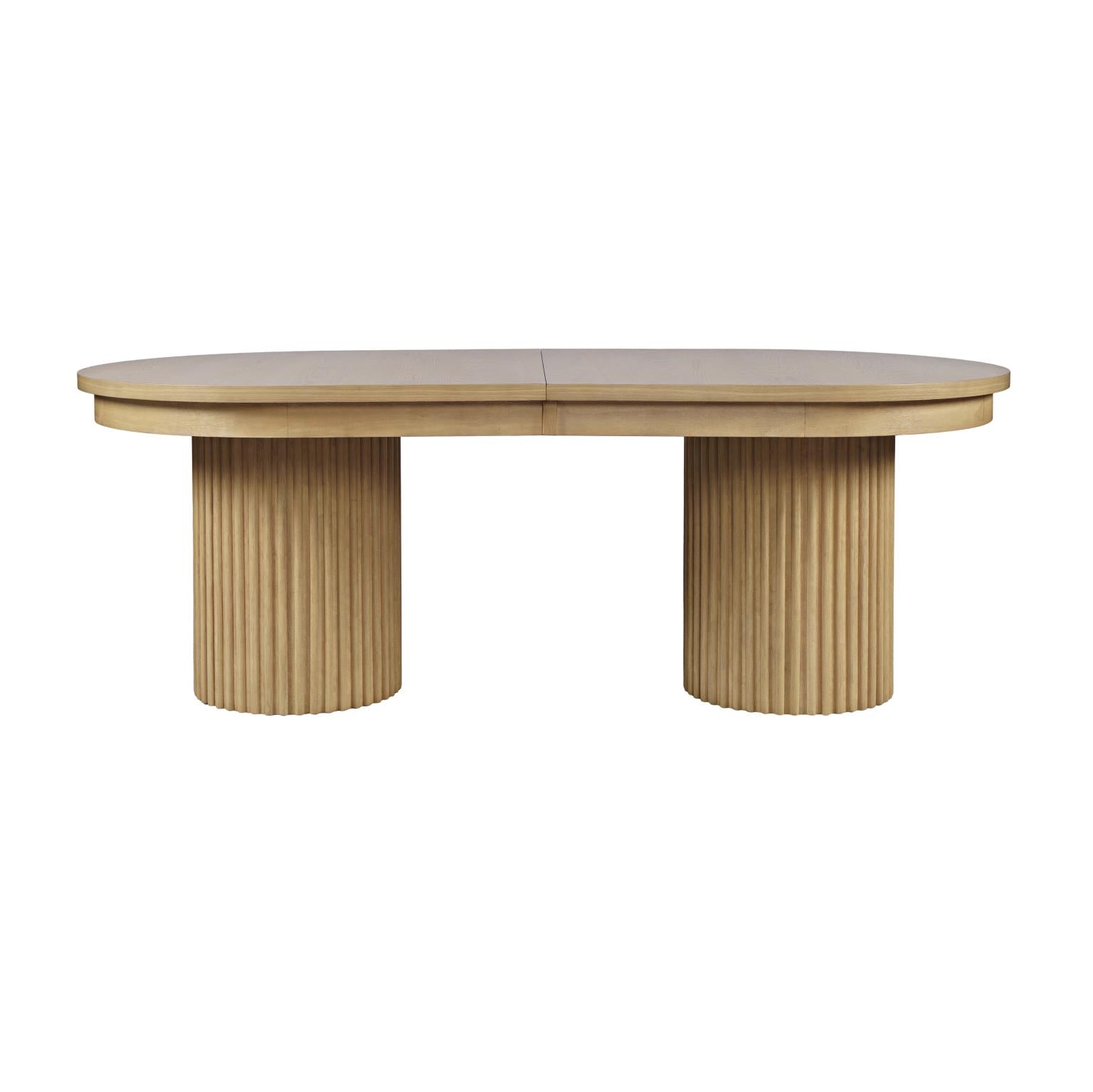Front view of the Nord dining table in a natural oak finish featuring an oval tabletop and two thick fluted pedestal bases