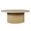 Front view of the Nord coffee table featuring a circular natural oak top and a decorative fluted tambour pedestal base