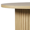Close-up shot highlighting the smooth rounded edge of the tabletop and the vertical texture of the fluted wood base