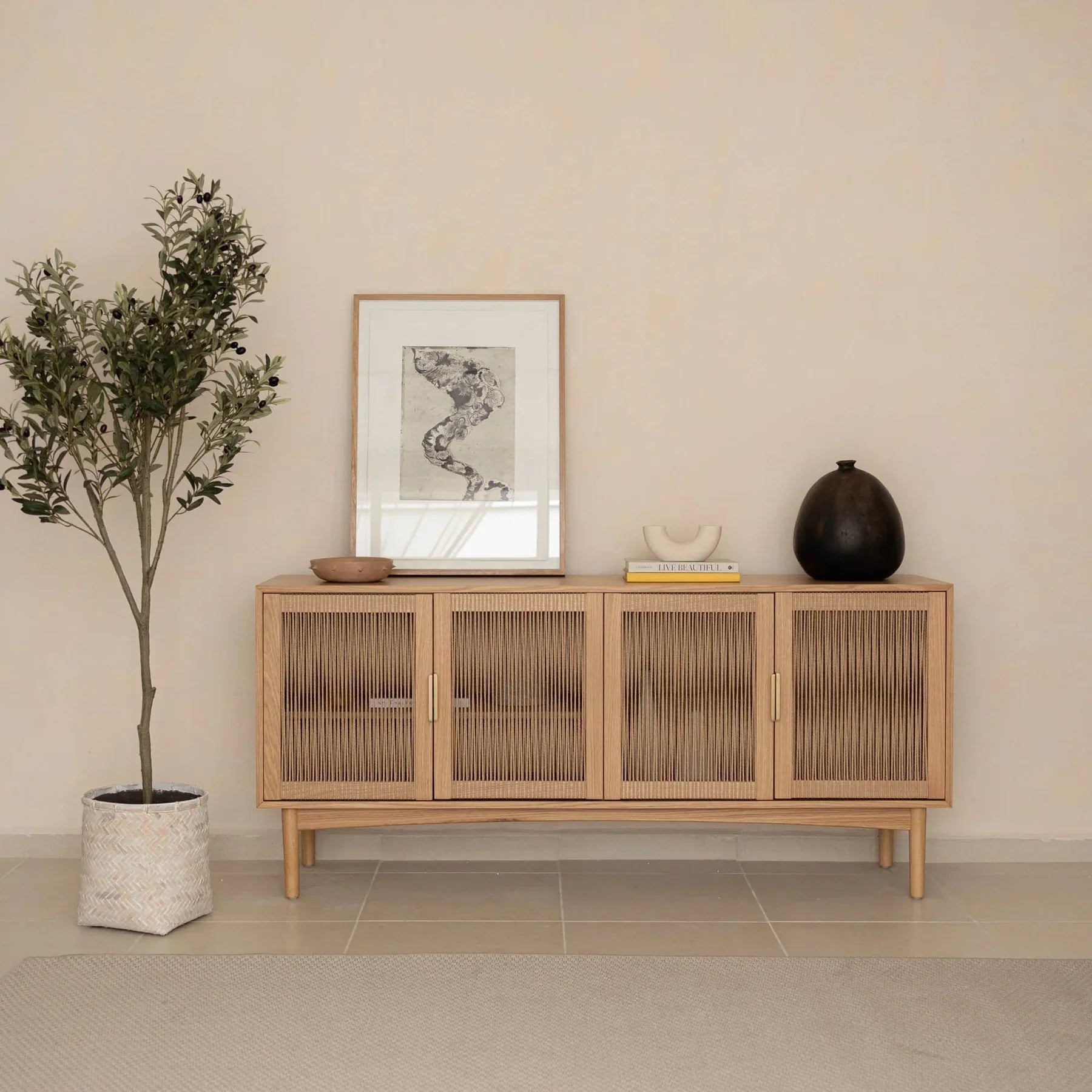 Front perspective view of the Lumina 4-door sideboard featuring a light oak wood frame, fluted glass door panels, and elegant vertical gold metal handles