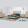 Studio lifestyle shot featuring the dresser in a bright, modern bedroom setting with a matching bed and colorful geometric rug