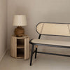 Side view showing the Oasis table with its hidden door open to reveal a circular internal storage compartment